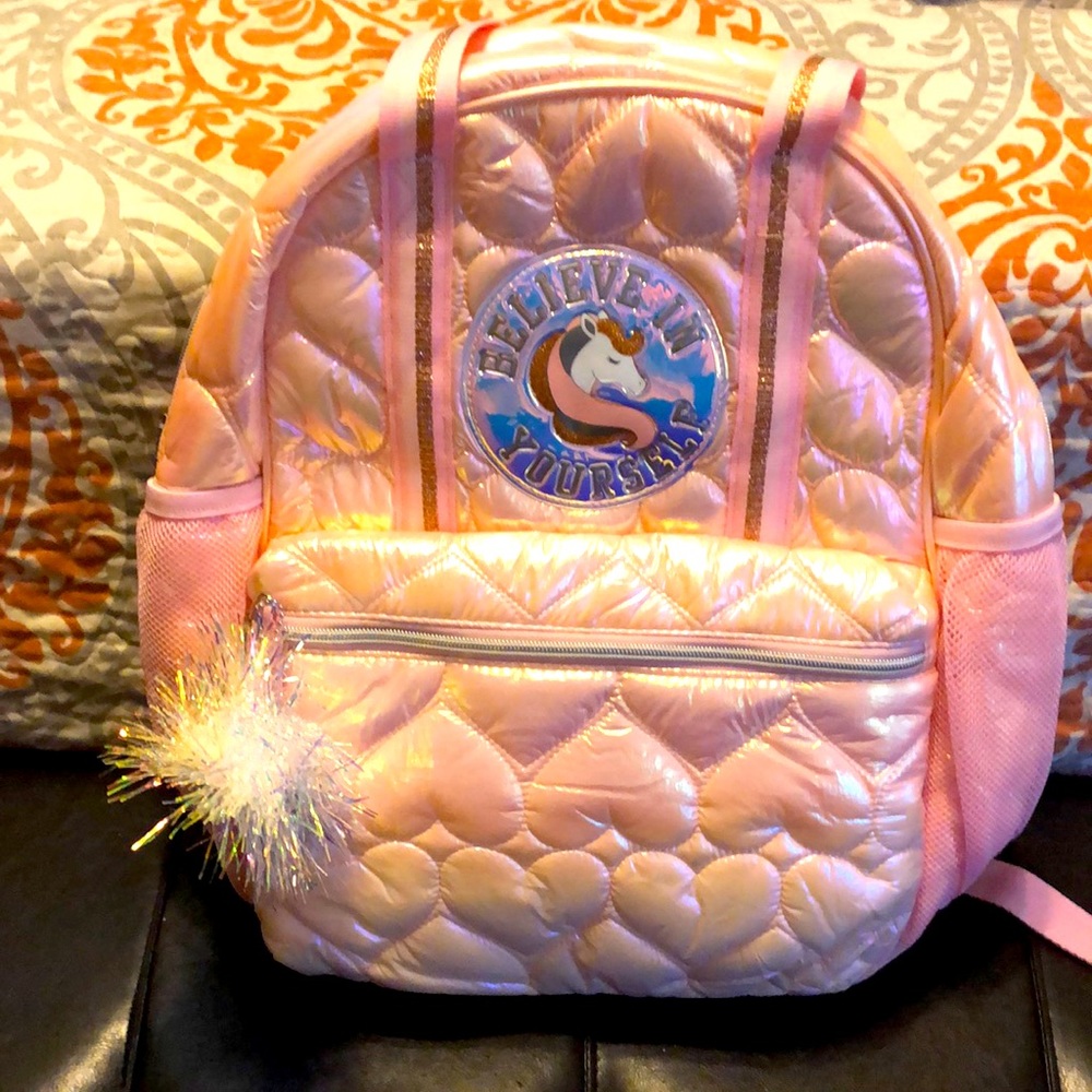 Pink book bag with the sayings believe in yourself